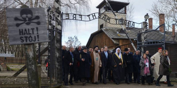 Mohammad Al-Issa, secretary-general of the Muslim World League, seventh from right, visits Auschwitz with David Harris, seventh from left, CEO of the American Jewish Committee, on Jan. 23, 20