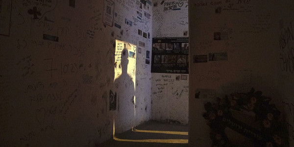 A man casts a shadow on the wall as he enters the roadside bomb shelter where Ziv Abud survived, protected by the crush of bodies above her, during the Hamas attack(AP Photo/Leo Correa)